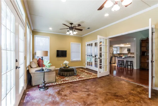 a living room with furniture a flat screen tv and a large window
