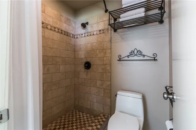 a bathroom with a toilet and shower