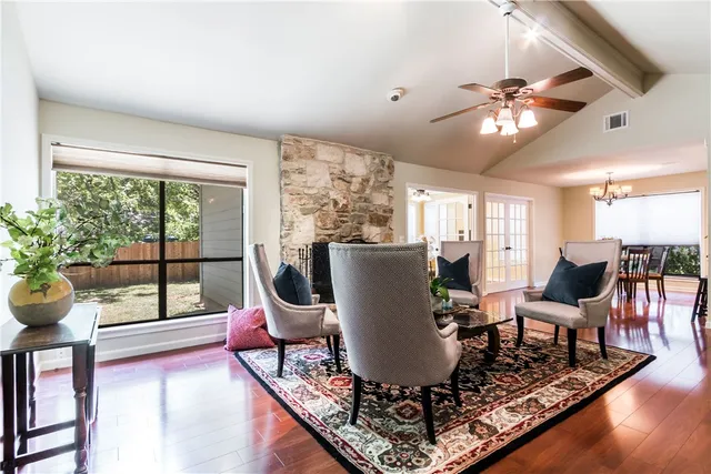 a living room with furniture a window and a potted plant
