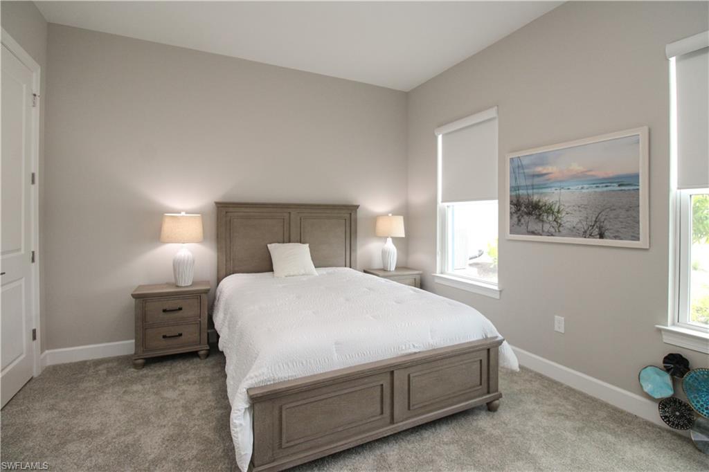 15765 Cortina Street Naples, FL 34114 - Photo 12 of 50 a bedroom with a bed and night stand