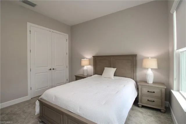 a bedroom with a bed and a lamp