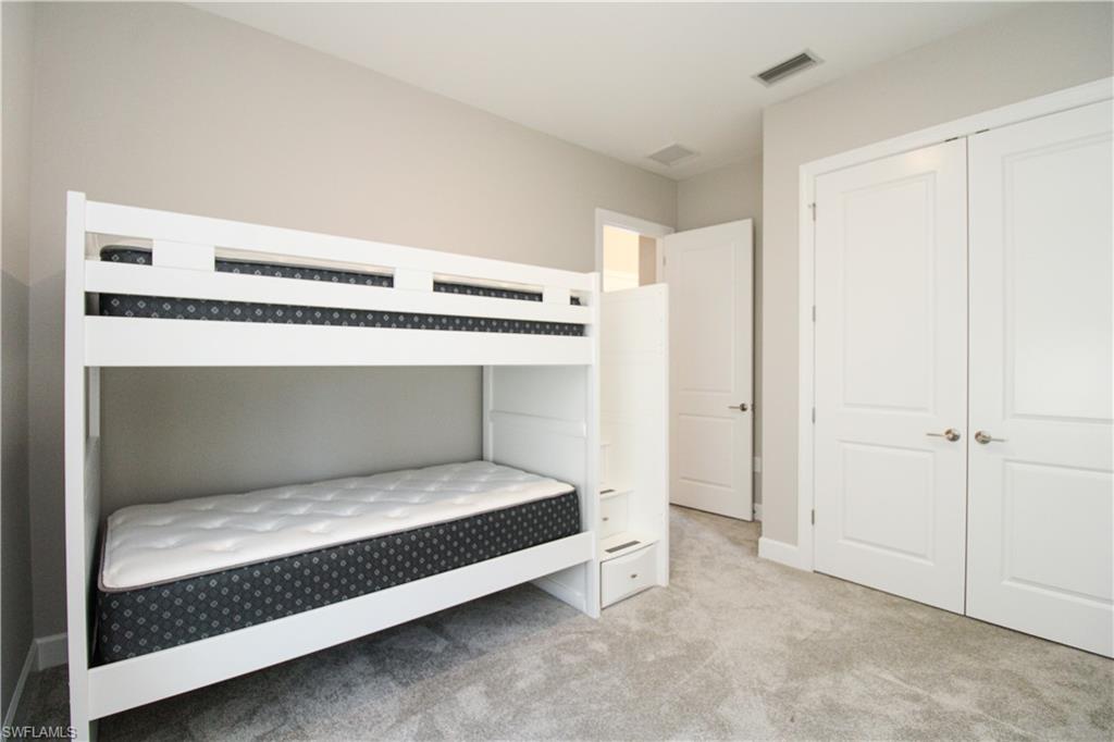 15765 Cortina Street Naples, FL 34114 - Photo 16 of 50 a bedroom with a bed and a window