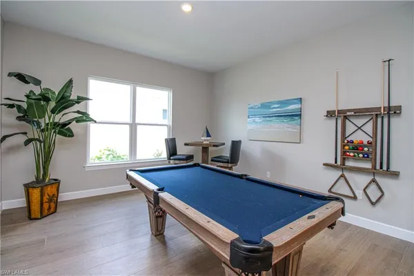 a room with gym equipment and a potted plant