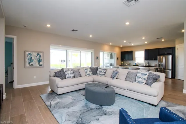 a living room with furniture and kitchen view