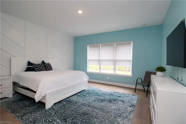 a bedroom with a bed and a window