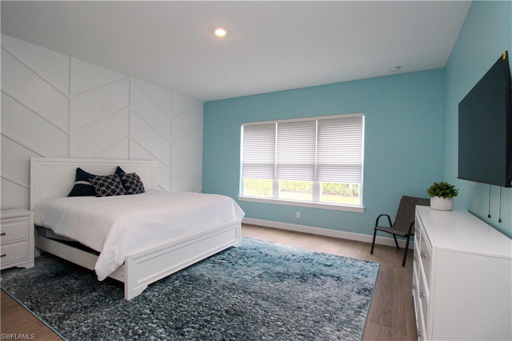 15765 Cortina Street Naples, FL 34114 - Photo 32 of 50 a bedroom with a bed and a window
