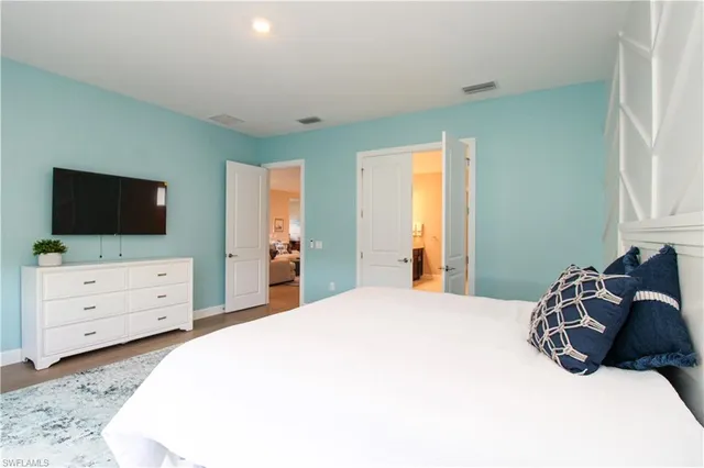 a bedroom with a bed and a flat screen tv