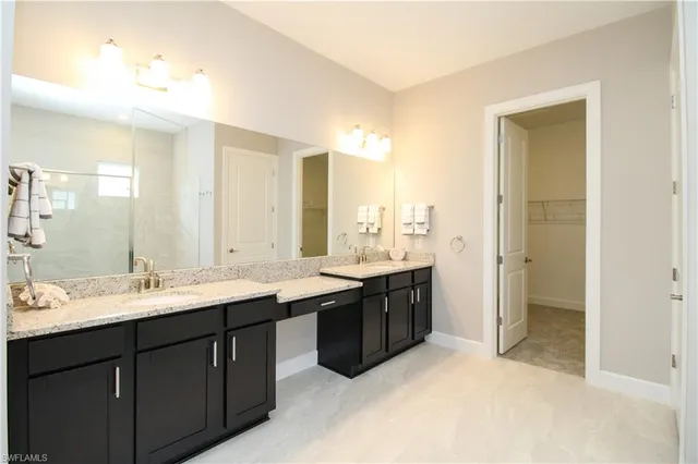 a bathroom with a double vanity sink mirror and double