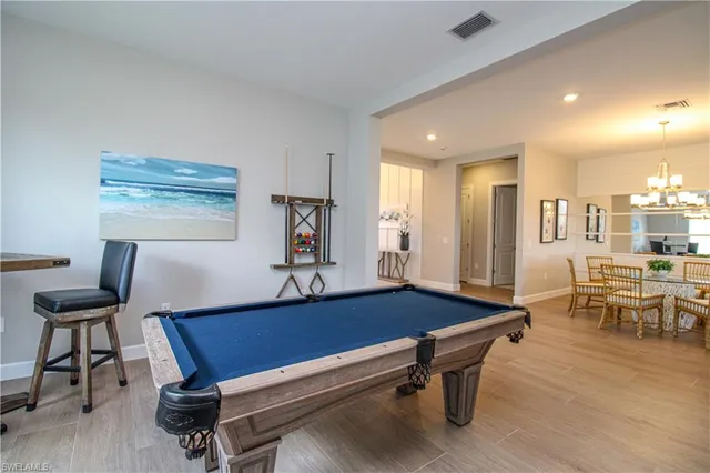 a living room with furniture pool table and a window