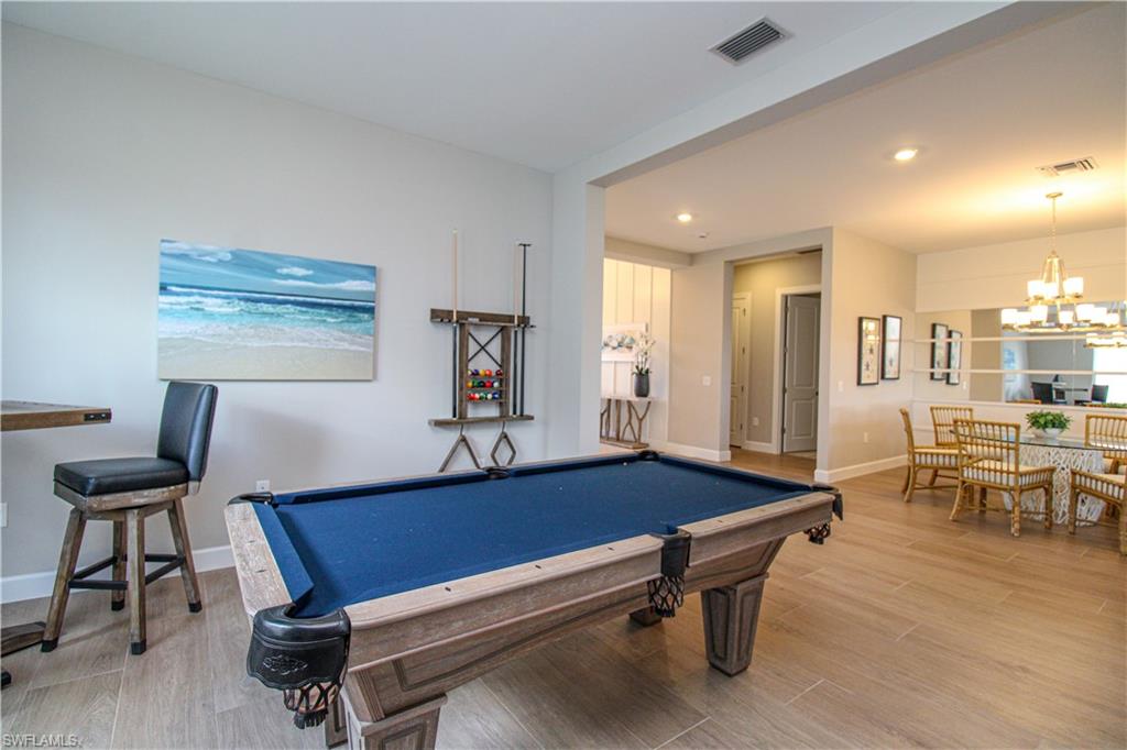 15765 Cortina Street Naples, FL 34114 - Photo 39 of 50 a living room with furniture pool table and a window