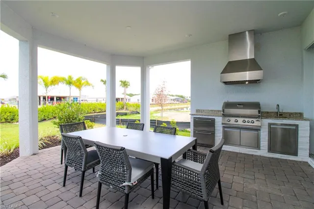 a dining room with furniture and a floor to ceiling window