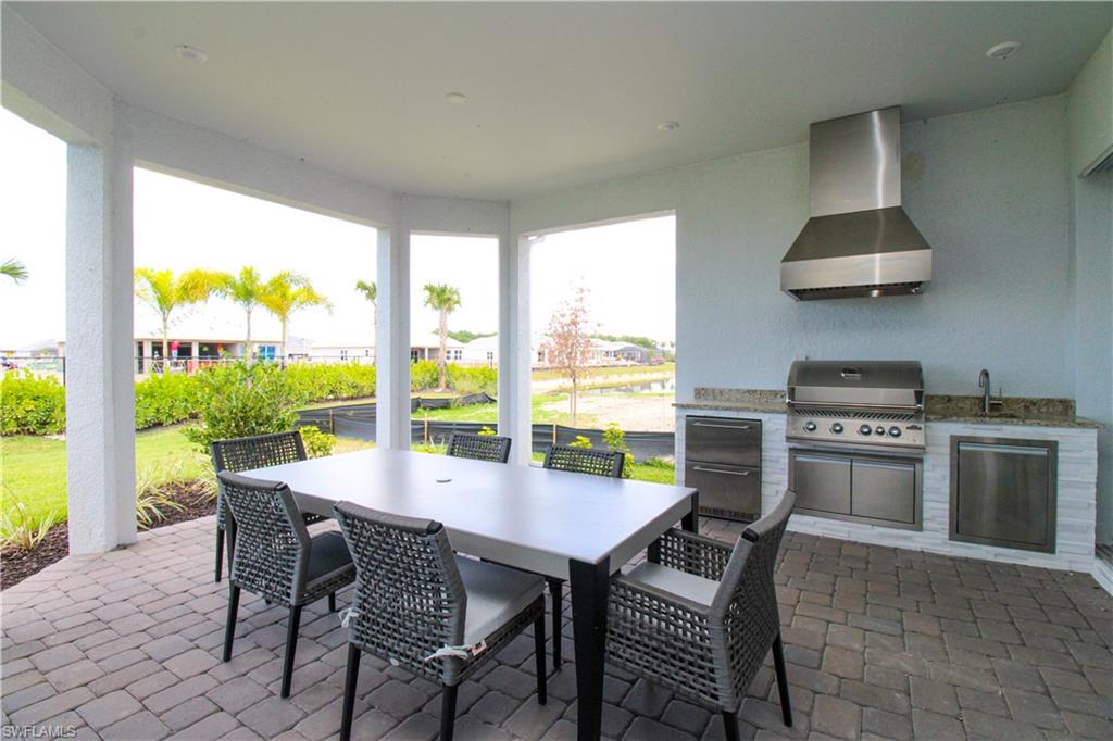 15765 Cortina Street Naples, FL 34114 - Photo 40 of 50 a dining room with furniture and a floor to ceiling window