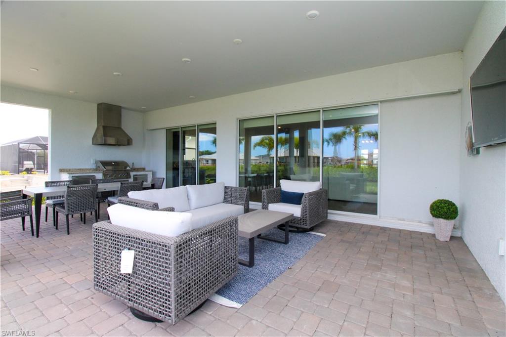 15765 Cortina Street Naples, FL 34114 - Photo 42 of 50 a living room with furniture and a potted plant