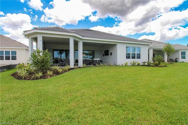 a view of a house with a big yard and potted plants
