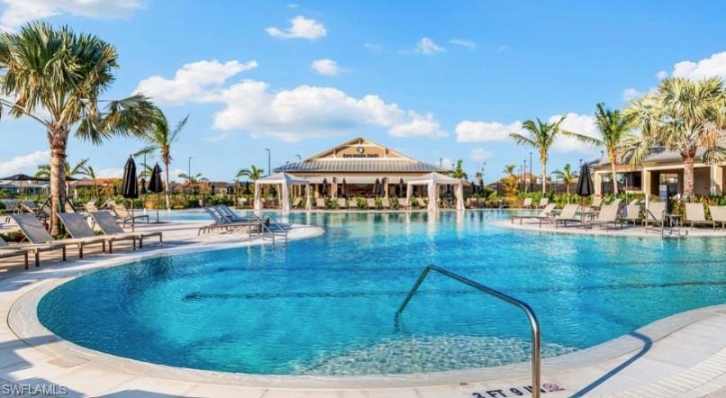 15765 Cortina Street Naples, FL 34114 - Photo 46 of 50 a swimming pool with outdoor seating and yard