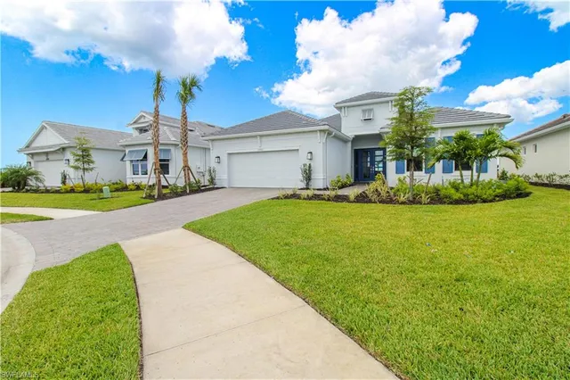 a front view of house with yard and green space