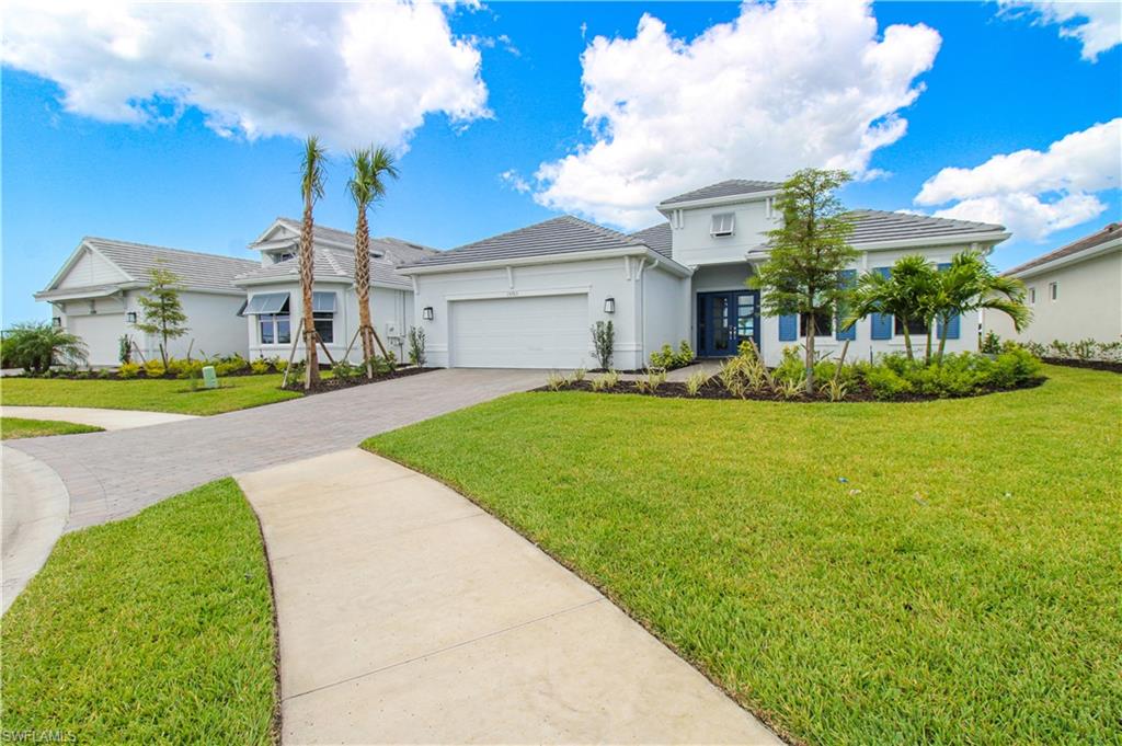 15765 Cortina Street Naples, FL 34114 - Photo 6 of 50 a front view of house with yard and green space
