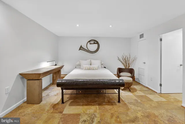 a bedroom with a bed and a table in it