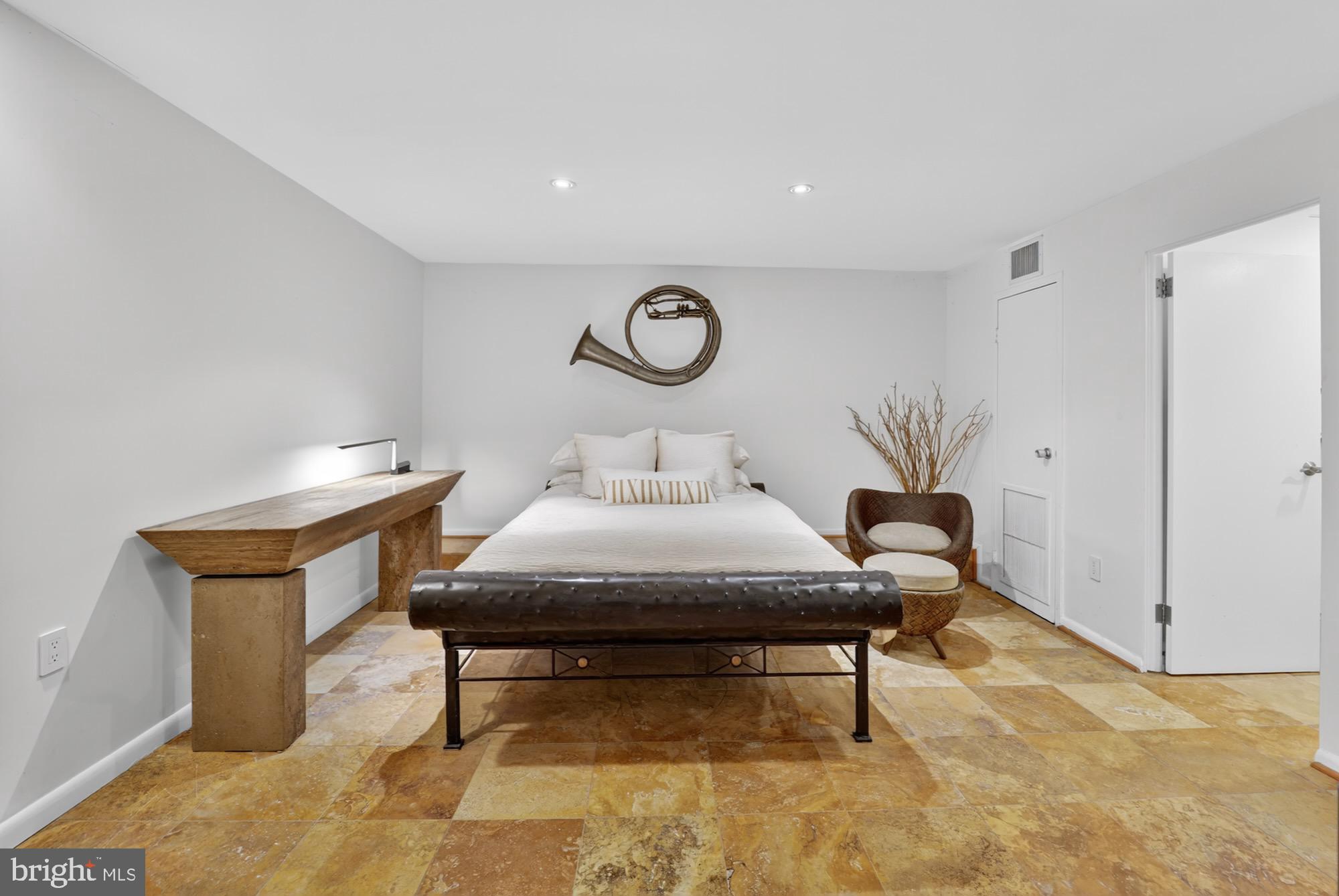 4100 Cathedral Avenue Northwest, Unit 615 Washington, DC 20016 - Photo 14 of 26 a bedroom with a bed and a table in it