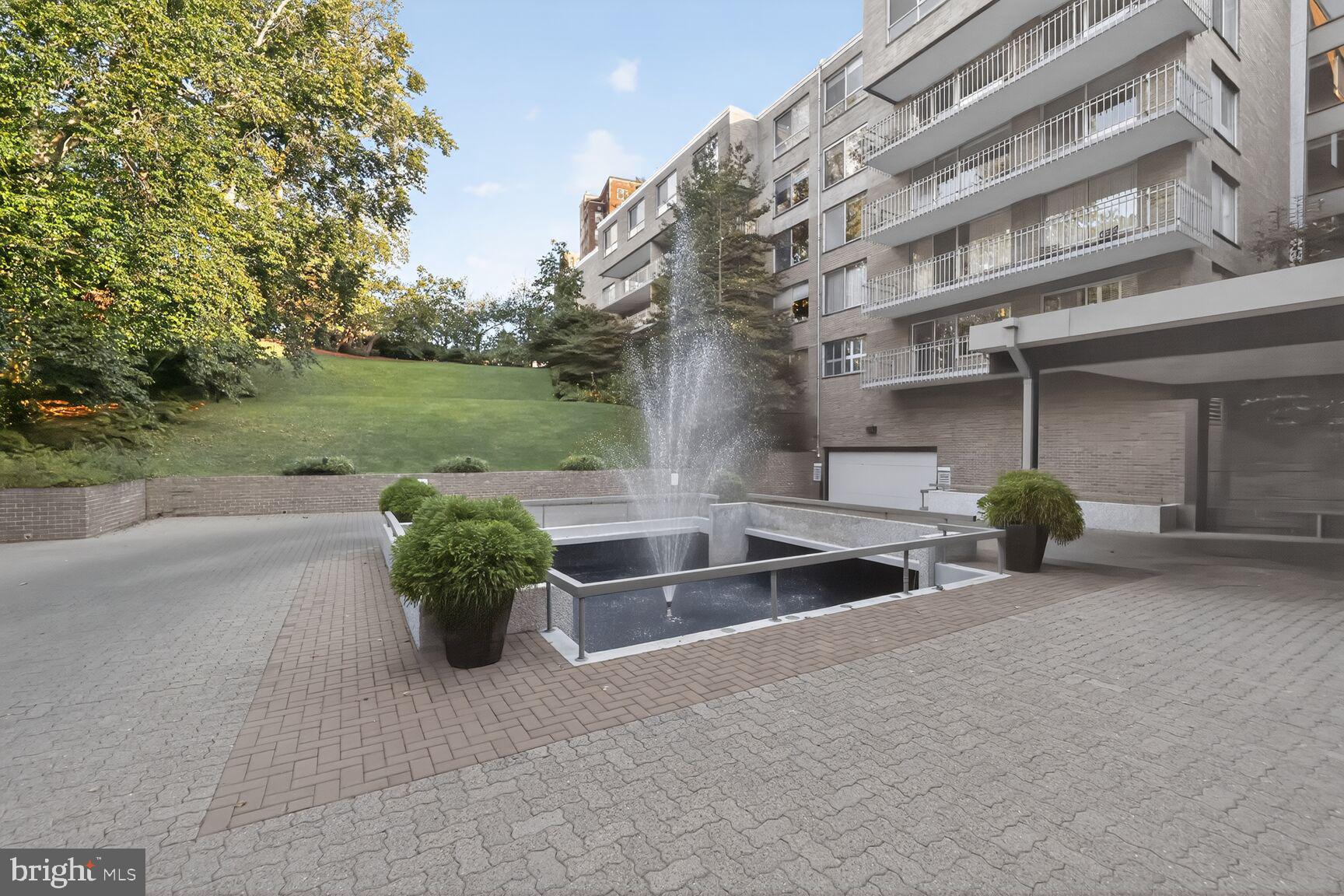 4100 Cathedral Avenue Northwest, Unit 615 Washington, DC 20016 - Photo 26 of 26 a view of a swimming pool with a patio and a yard