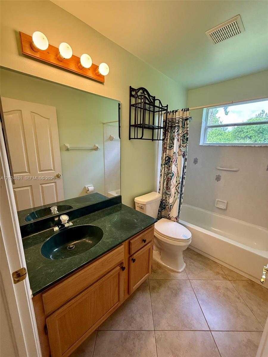 15819 76th Road North Loxahatchee, FL 33470 - Photo 43 of 45 a bathroom with a granite countertop sink toilet and shower