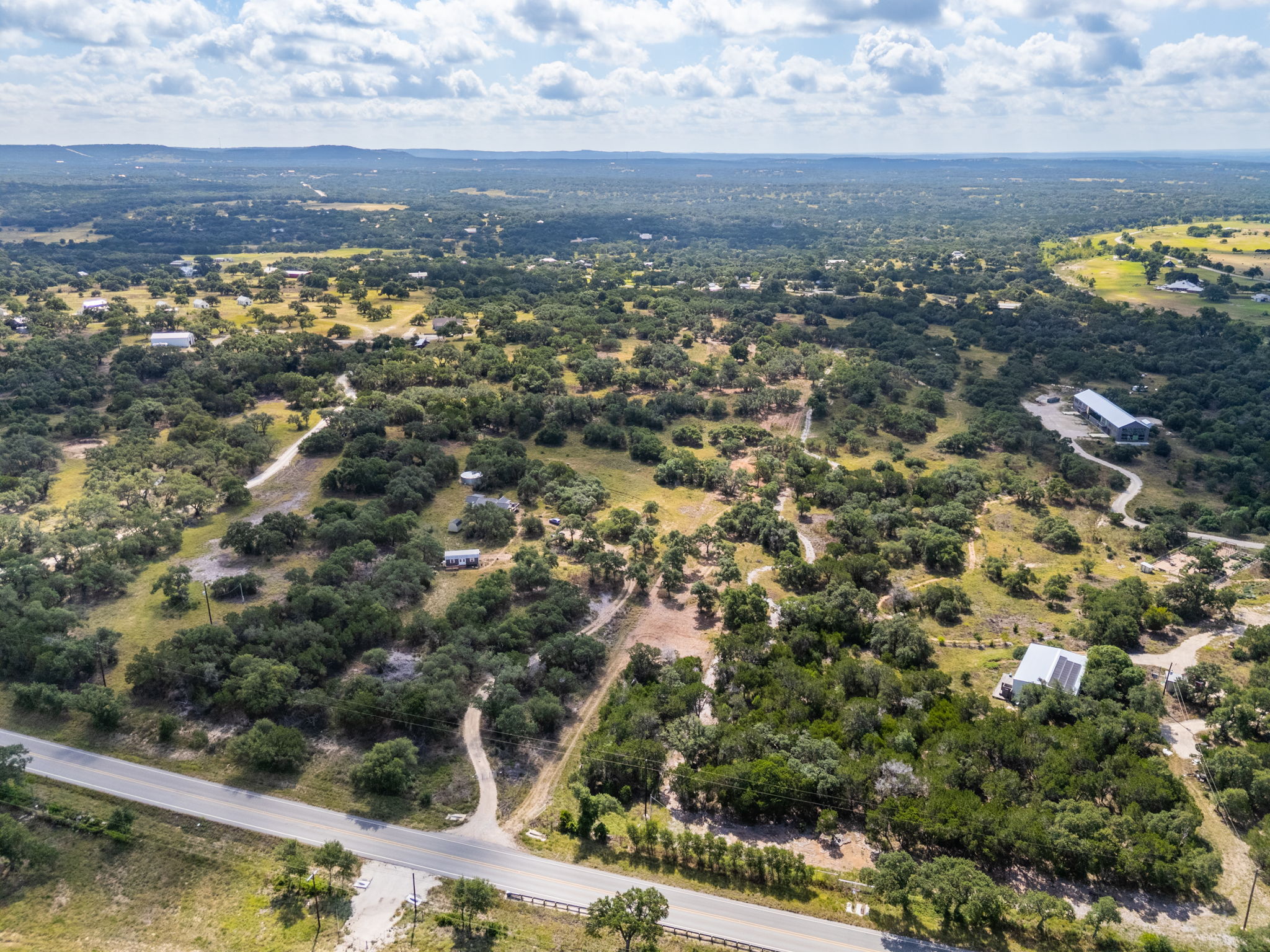 5385 Ranch Road 165 Blanco, TX 78606 - Photo 16 of 40 Vast, verdant landscape with scattered properties offers a serene, rural escape.