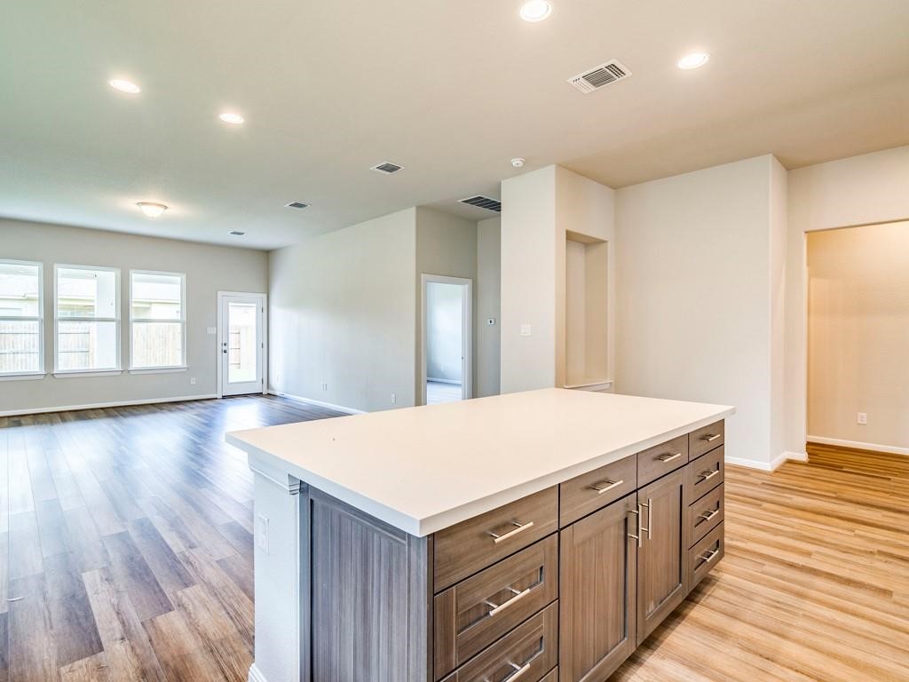 270 Rimrock Court Bastrop, TX 78602 - Photo 16 of 34 Inside, the open-concept kitchen is the heart of the home, featuring stainless steel appliances, a generous island, and plenty of space to gather, cook, and connect.