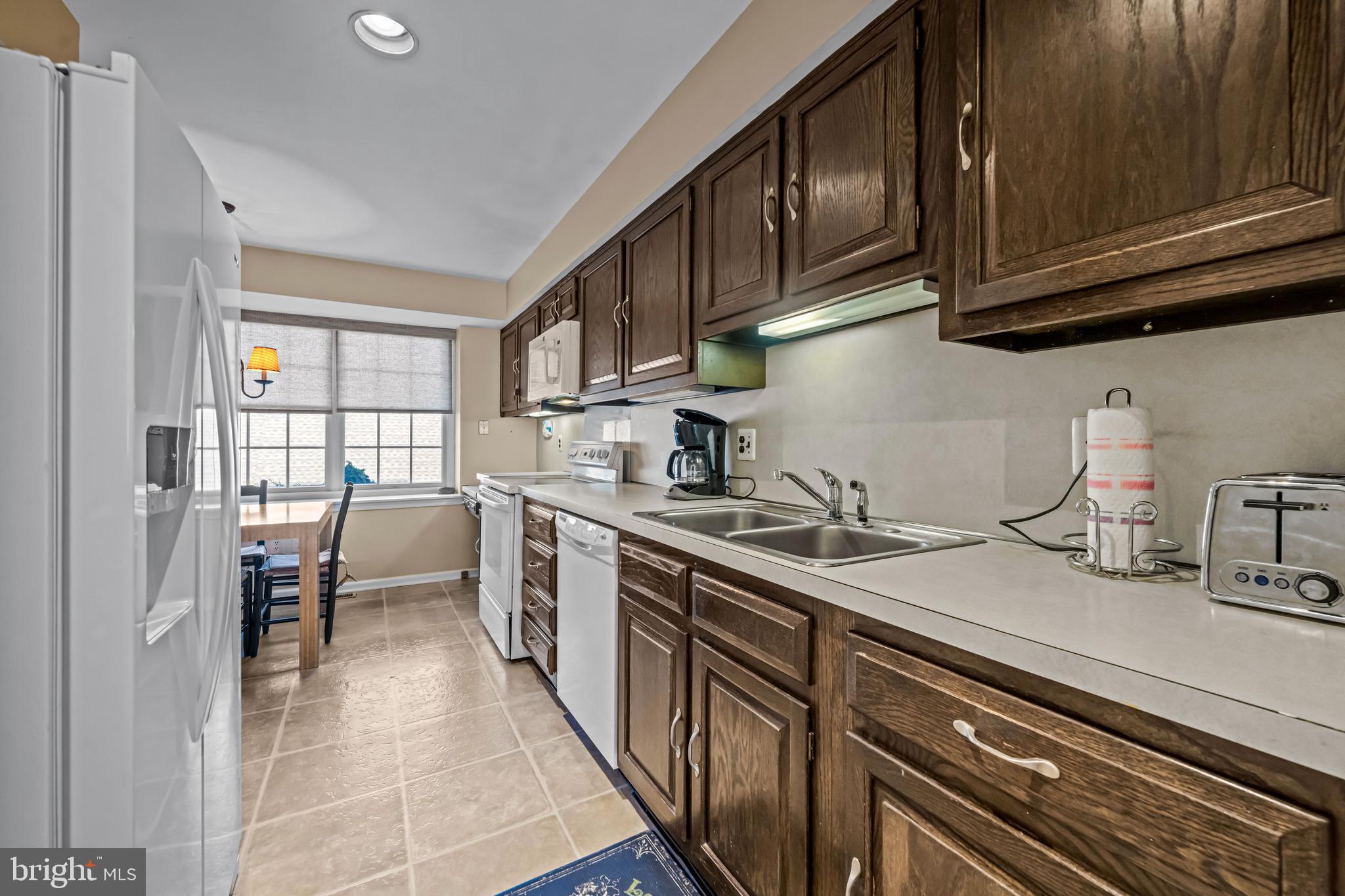 633 East Main Street, Unit B7 Moorestown, NJ 08057 - Photo 11 of 42 a kitchen with stainless steel appliances granite countertop a sink stove and cabinets