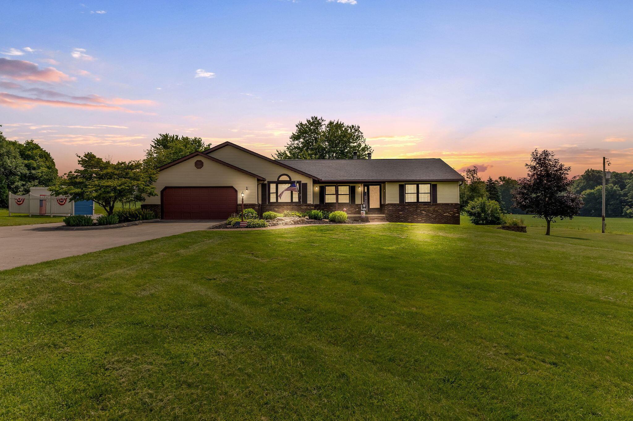6651 Lancaster Road Hebron, OH 43025 - Photo 2 of 88 Imagine enjoying a perfect twilight evening in your new home, where peaceful surroundings and stunning views create the ideal setting to unwind and relax.
