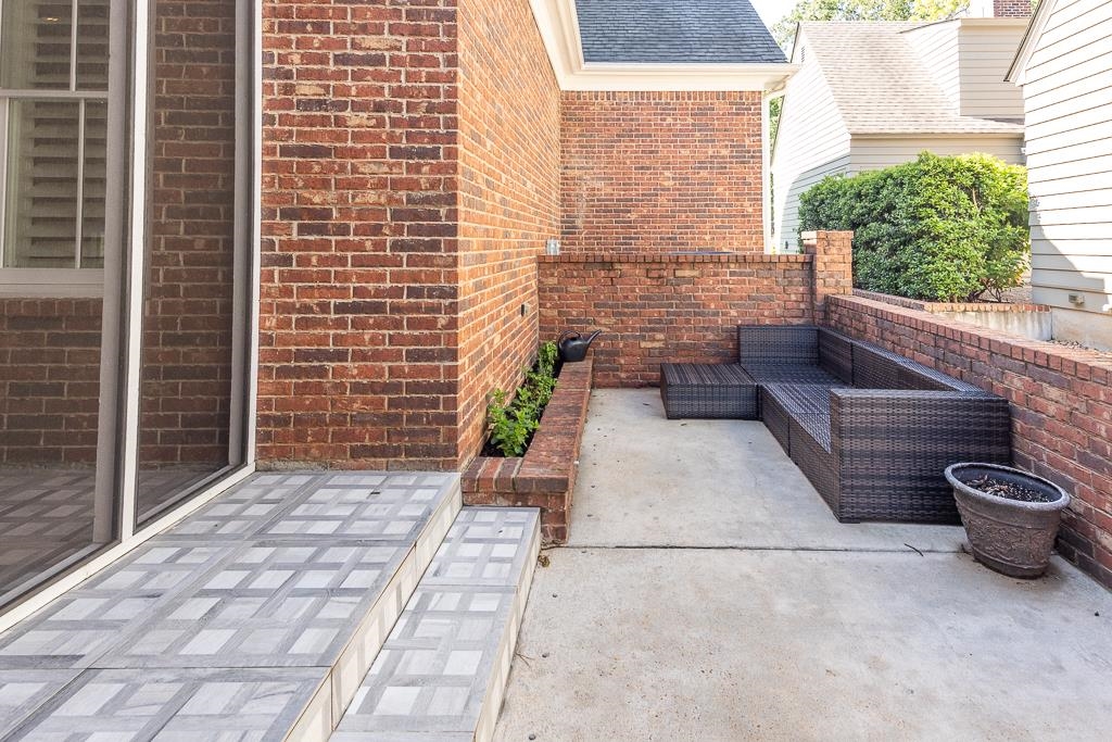328 Washington Street Collierville, TN 38017 - Photo 29 of 33 Private patio area featuring brick walls and concrete flooring