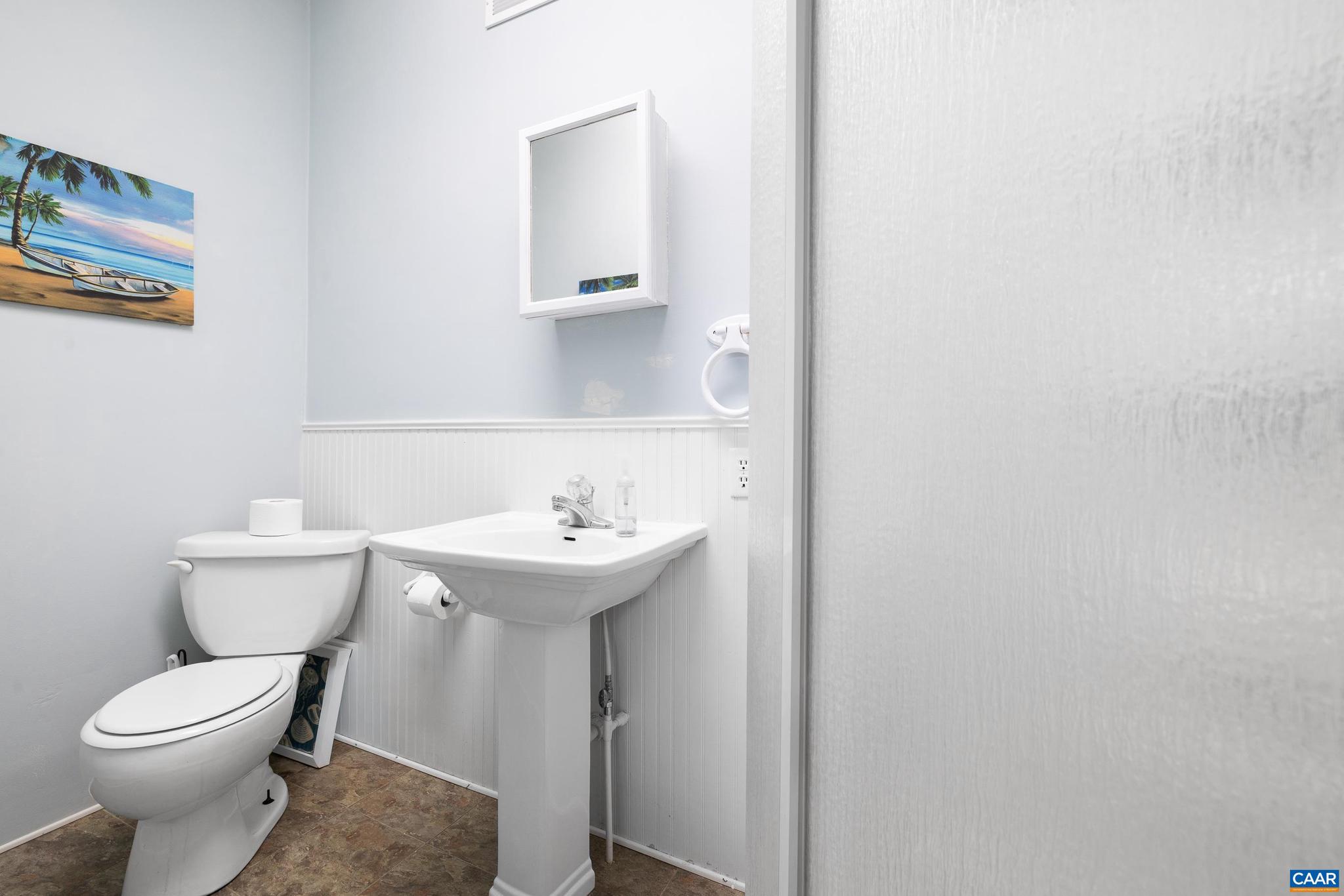 752 Westwood Road Stanardsville, VA 22973 - Photo 21 of 63 a white toilet sitting next to a bathroom sink