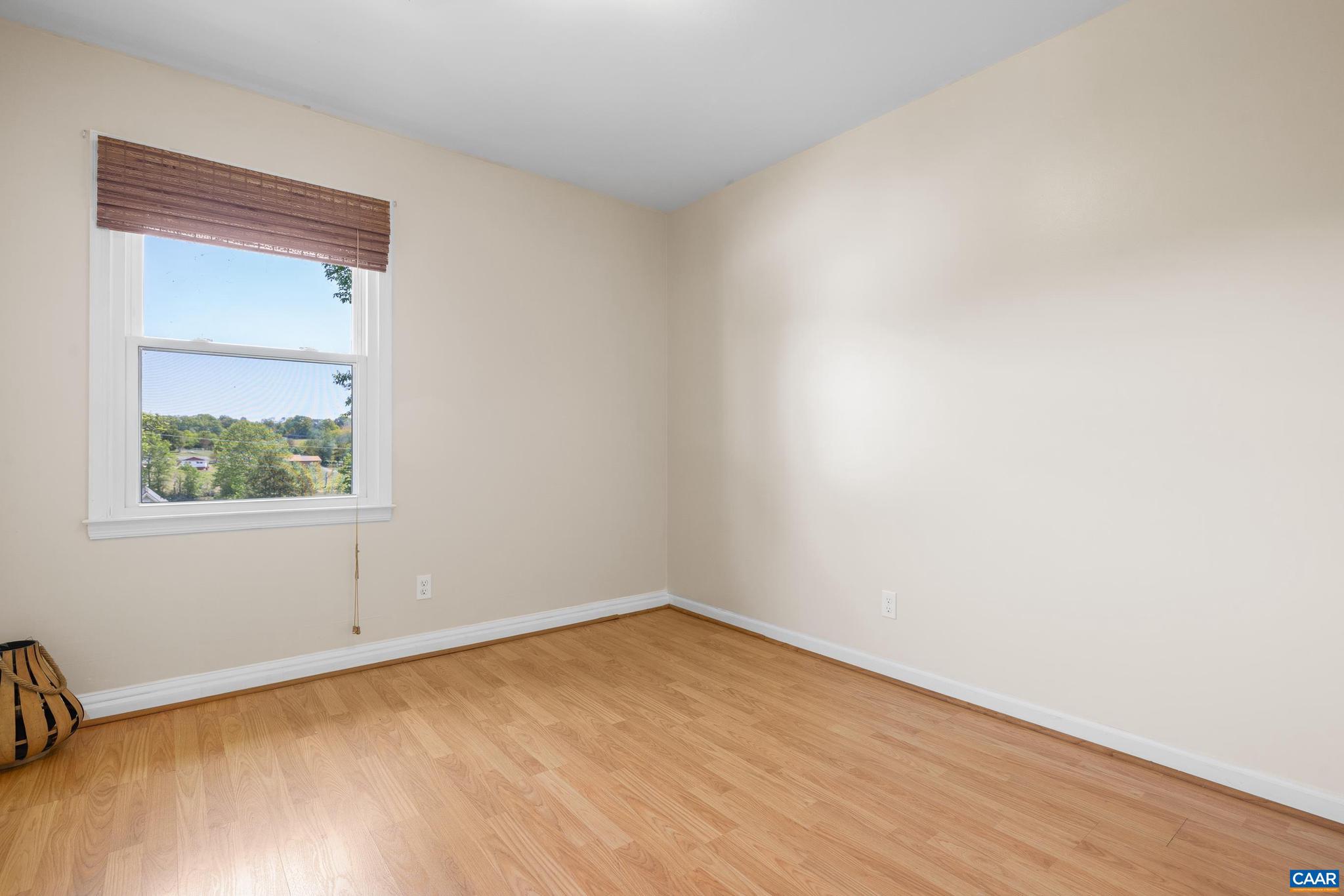 752 Westwood Road Stanardsville, VA 22973 - Photo 29 of 63 a view of an empty room with wooden floor and a window