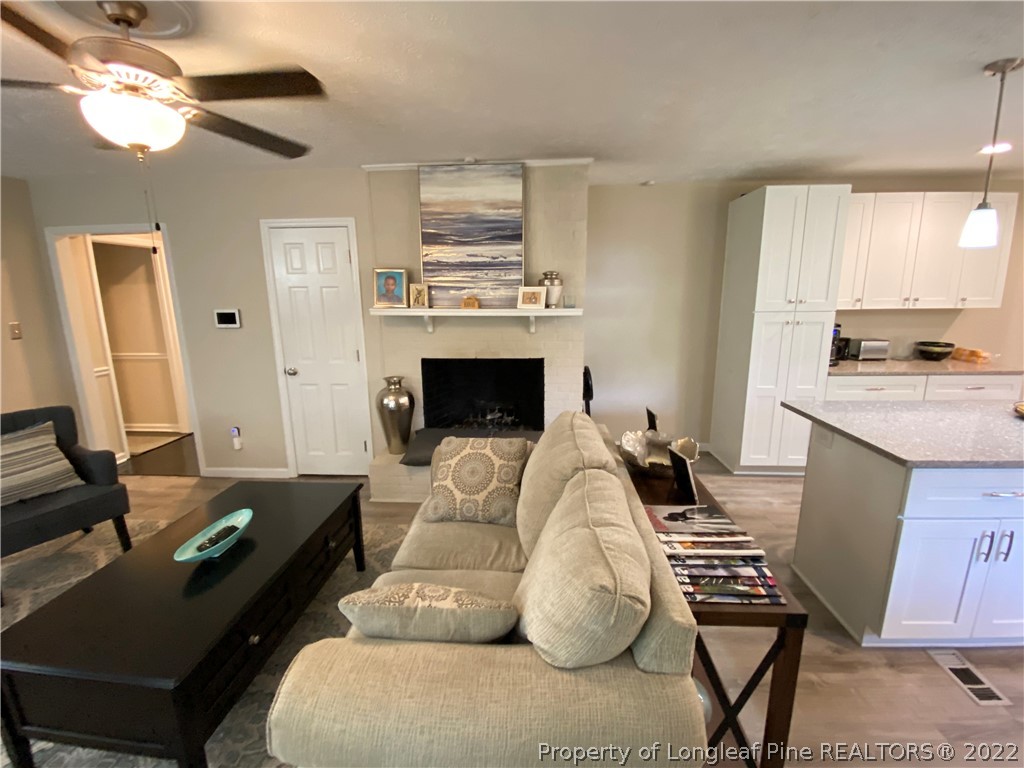 215 Rivenoak Drive Fayetteville, NC 28303 - Photo 12 of 21 a living room with furniture fireplace and a flat screen tv