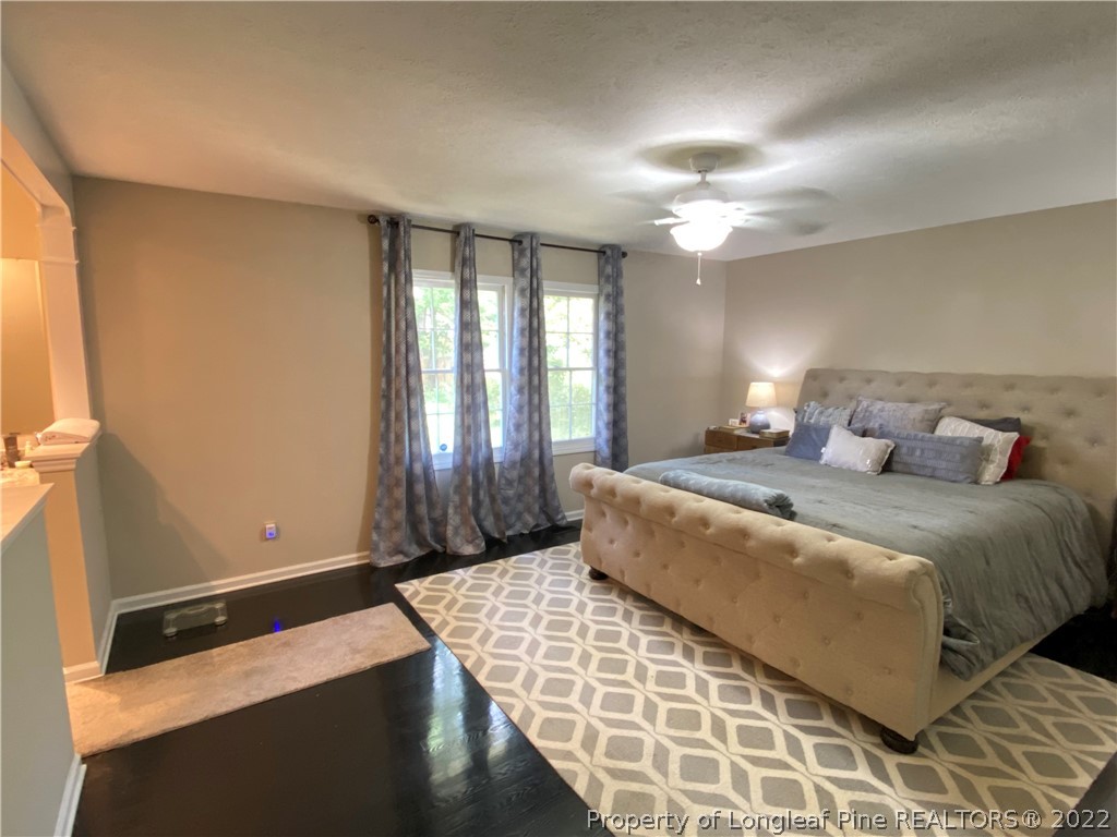 215 Rivenoak Drive Fayetteville, NC 28303 - Photo 16 of 21 a bedroom with a large bed and a chandelier