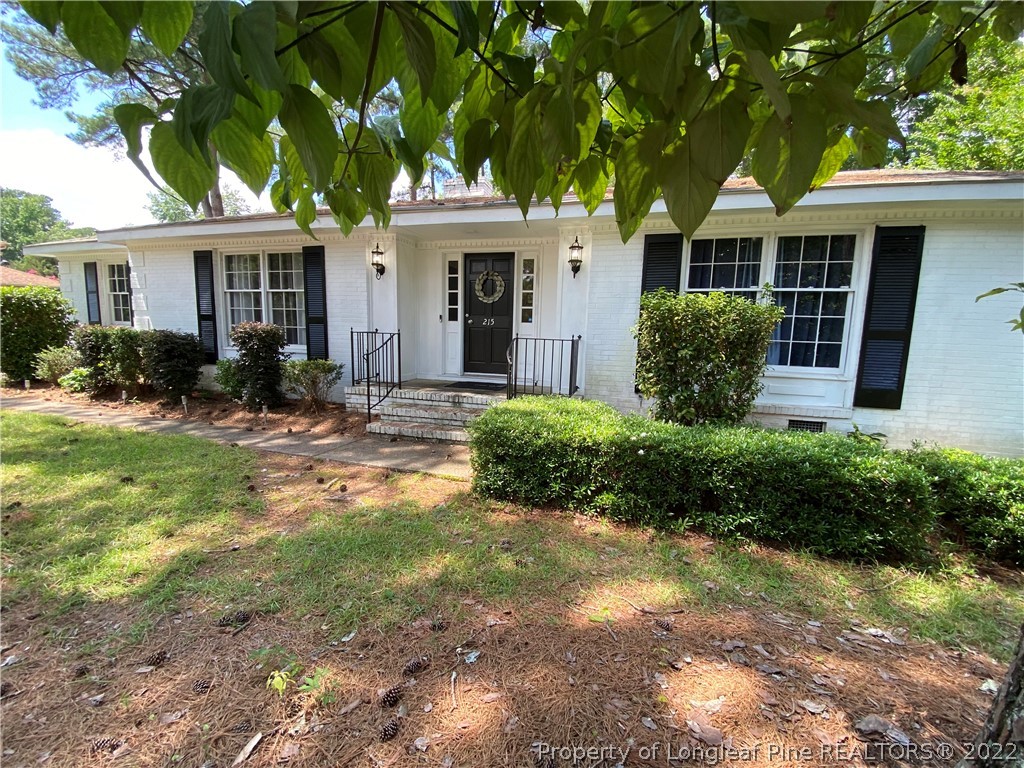 215 Rivenoak Drive Fayetteville, NC 28303 - Photo 2 of 21 a front view of a house with a yard and potted plants