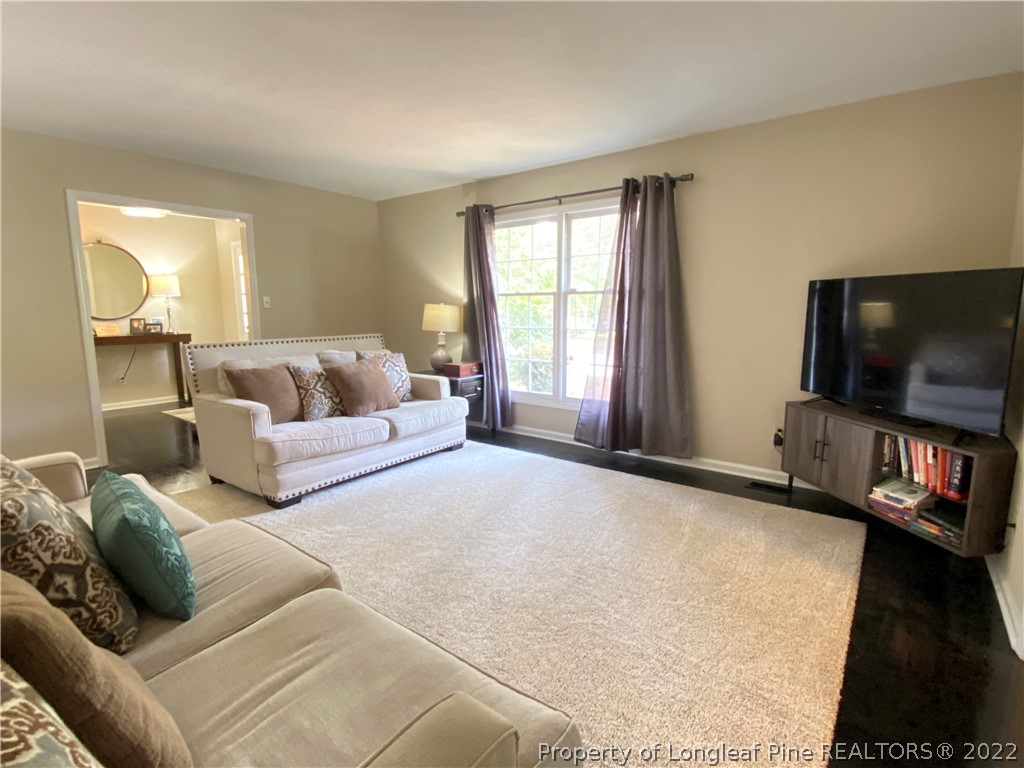 215 Rivenoak Drive Fayetteville, NC 28303 - Photo 4 of 21 a living room with furniture and a flat screen tv