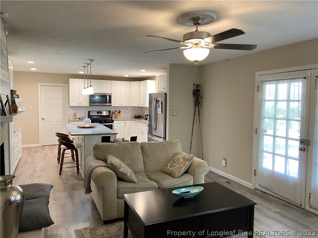 215 Rivenoak Drive Fayetteville, NC 28303 - Photo 10 of 21 a view of kitchen with furniture and a chandelier