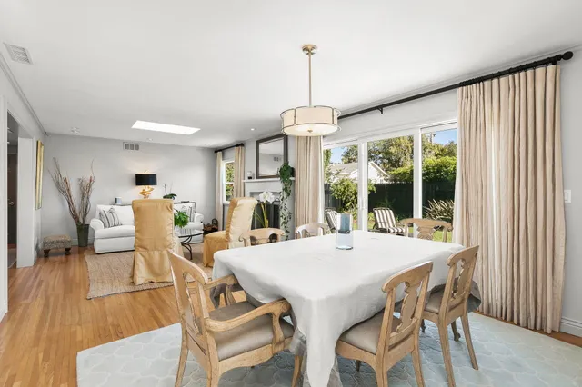 a large kitchen with granite countertop a large window and white stainless steel appliances