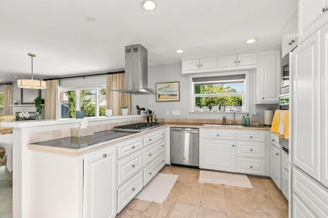 a kitchen with stove and cabinets