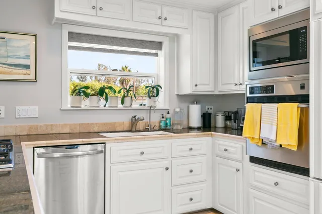 a bedroom with a bed a couch and dresser