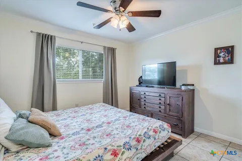a bedroom with a bed and flat screen tv