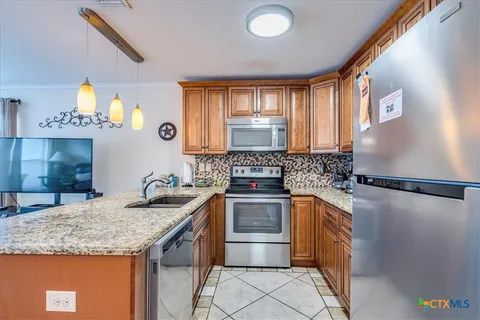 a kitchen with a sink a stove and cabinets