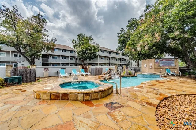a swimming pool with outdoor seating and yard