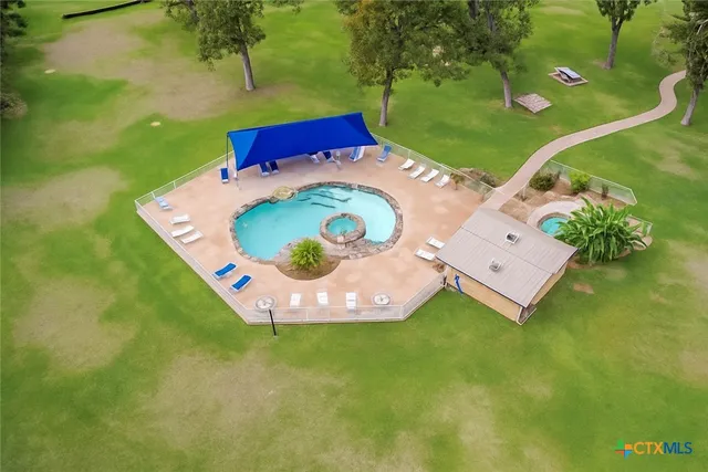 an aerial view of a house with a garden and swimming pool