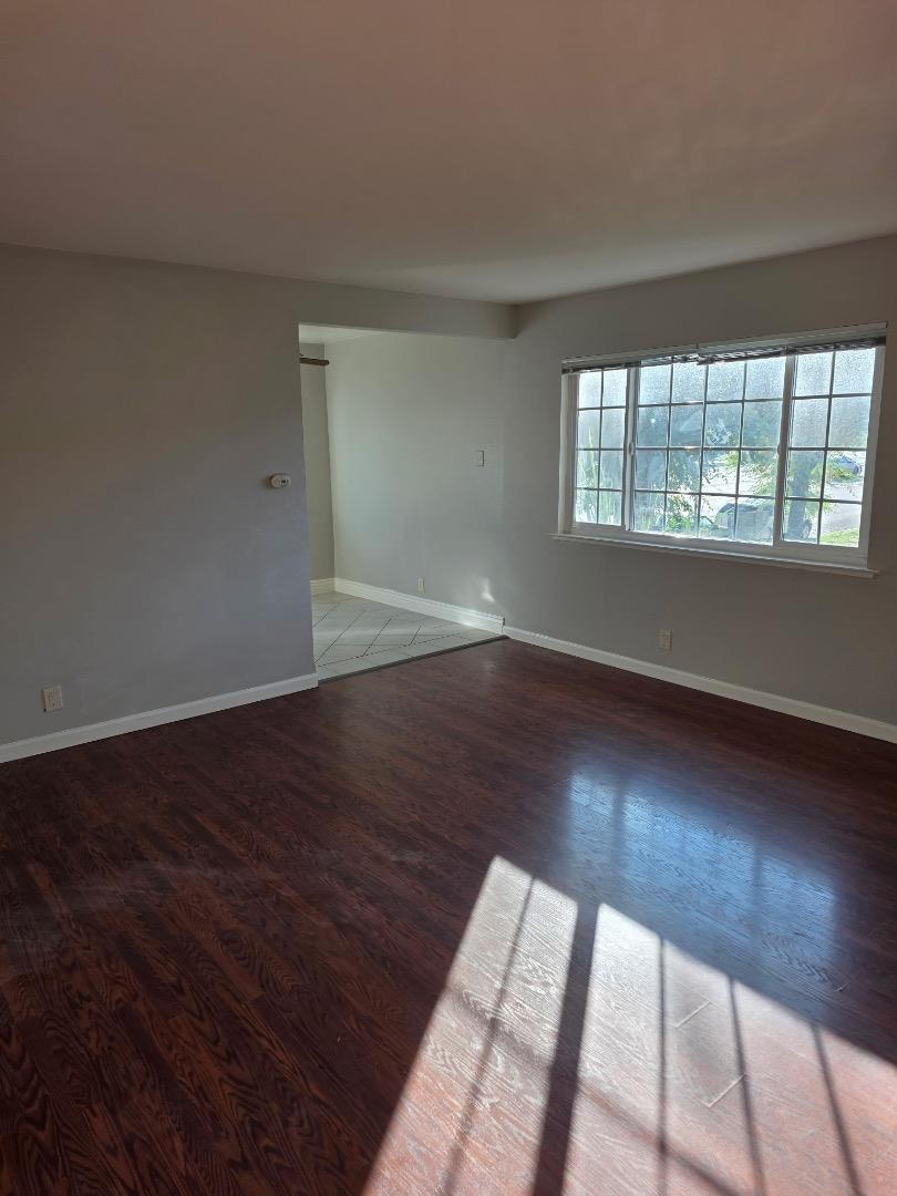 5745 Almaden Road, Unit D San Jose, CA 95118 - Photo 5 of 11 wooden floor in an empty room with a window