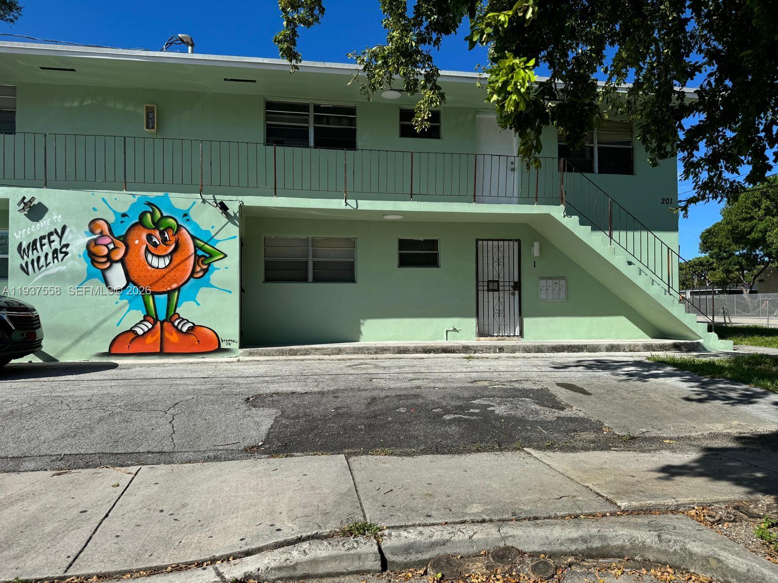 201 Northwest 77th Street, Unit 3 Miami, FL 33150 - Photo 13 of 15 a front view of a house with a garage