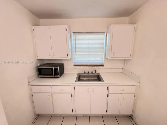 a utility room with cabinets washer and dryer