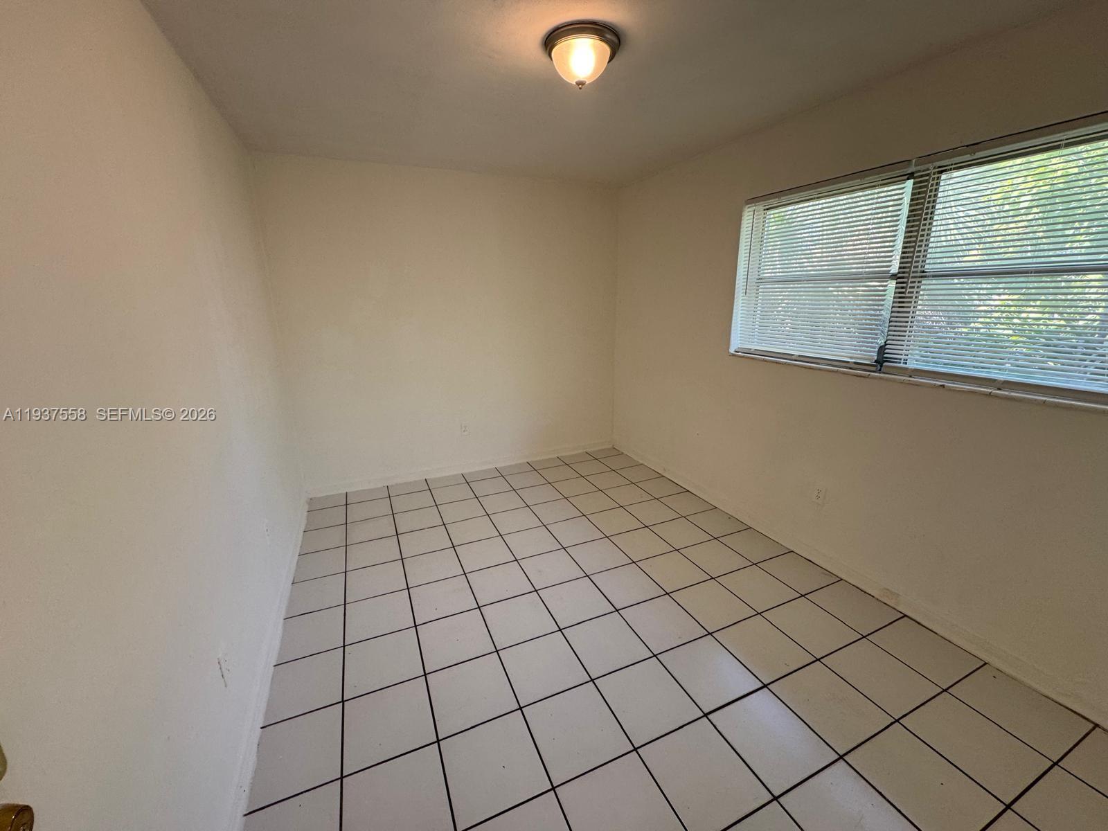 201 Northwest 77th Street, Unit 3 Miami, FL 33150 - Photo 10 of 15 a view of an empty room and window