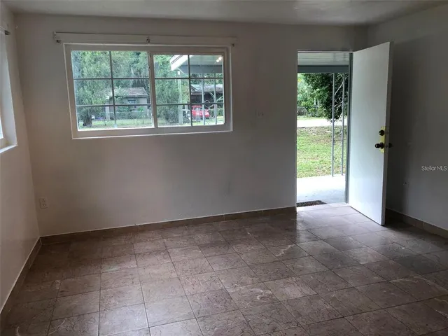 a view of an empty room with a window