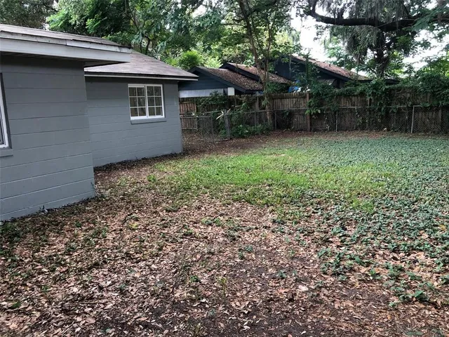 a backyard of a house with lots of green space